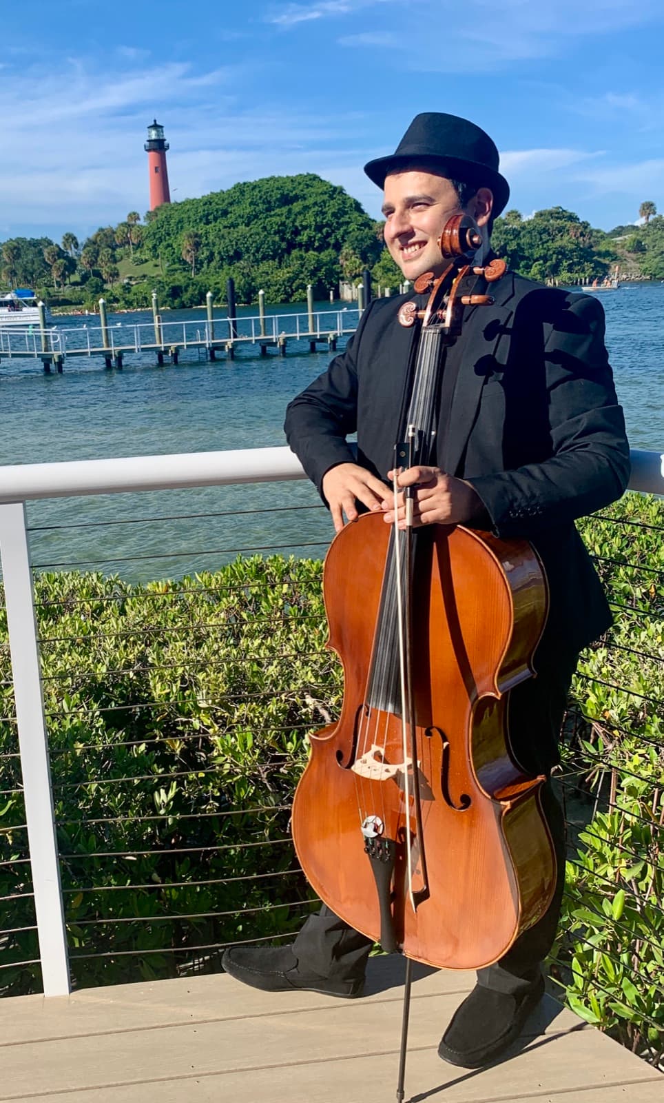 Aziz Sapaev with his cello at Jupiter Inlet, Florida